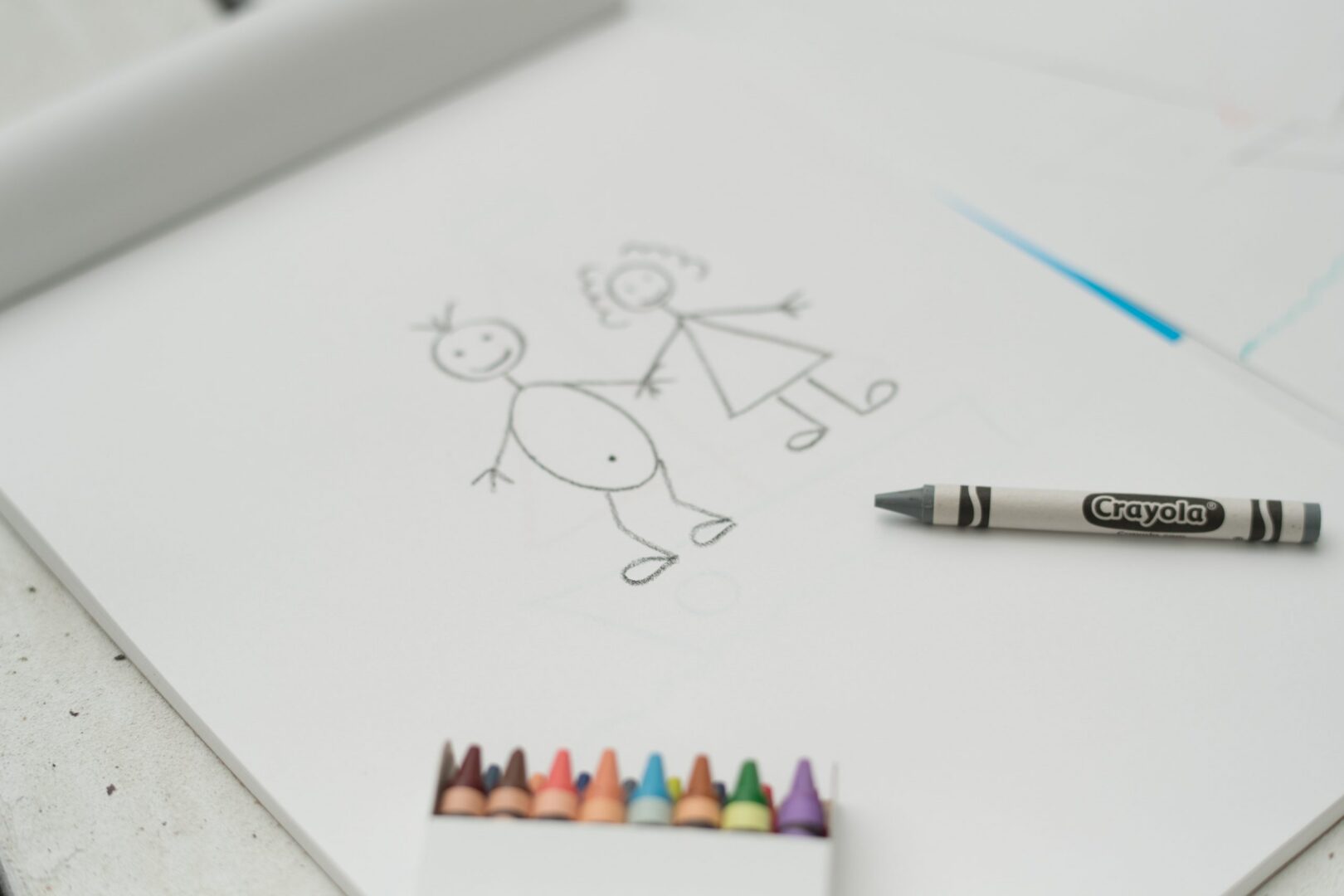 Child's stick-figure drawing with Crayola crayon